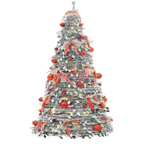 Pop-up foldable Christmas tree with snow flocked design, red ornaments and ribbon for holiday decor.