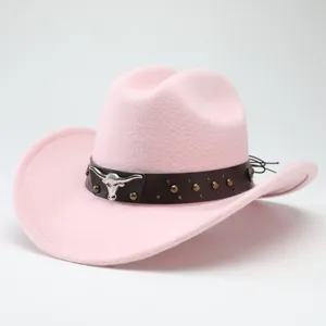 Pink felt western cowboy hat detail showcasing metal bull skull emblem and stud decorations.