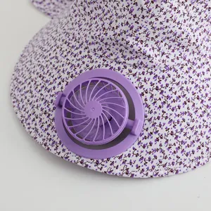 Detail view of the sun protection hat with a mini purple fan and floral pattern, close-up.