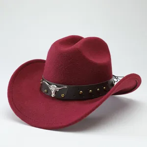 Red felt cowboy hat with leather band, metal bull skull and studs for western style.