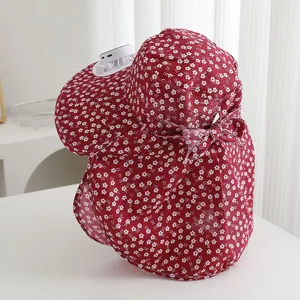 Red floral sun hat with solar powered fan and face cover cape for outdoor farm work.