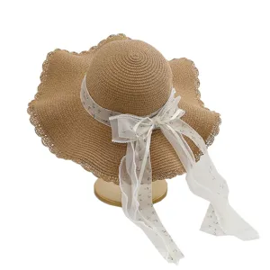 Elegante strohoed met brede rand en bloemenlint voor strandvakantie en zonbescherming.