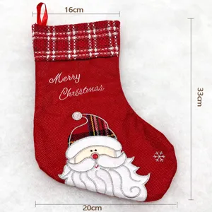 Red Christmas stocking with Santa Claus embroidery and plaid trim, holiday gift bag decor.