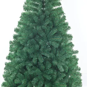 Detailed close-up of artificial Christmas tree branches with dense green PVC needles.