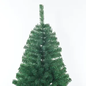Artificial Christmas tree detail top view, PVC flame retardant green pine branch foliage.