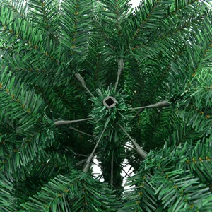 Detailed view of artificial green PVC Christmas tree branches, dense foliage structure.