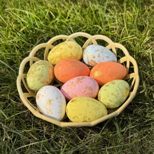 Colorful speckled Easter eggs in basket, mini foam decorative eggs for holiday home decor.