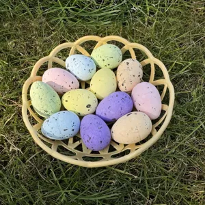 Detailed view of colorful speckled Easter eggs in a yellow basket, perfect for holiday decor.