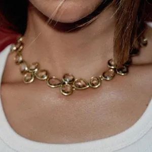 Detail shot of a geometric rhinestone choker necklace with colorful teardrop stones.