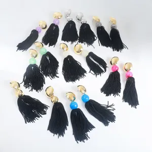 Detail shot of bohemian long black tassel earrings featuring metal discs and colorful acrylic beads.