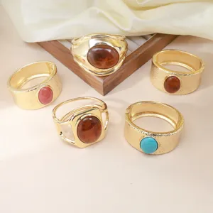 Exaggerated geometric fashion cuff bracelet detail, vintage textured metal with resin stone inlay.