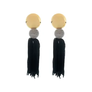 Bohemian long tassel earrings detail view, featuring gold discs and black thread fringes.
