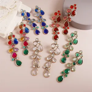 Exaggerated long teardrop rhinestone earrings detail view, colorful crystal fashion jewelry.