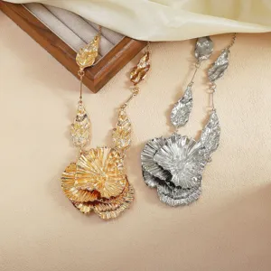 Exaggerated metallic floral leaf pendant necklace set in gold and silver, elegant statement jewelry.