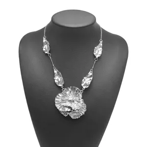 Exaggerated irregular pleated flower leaf pendant necklace with high-end metallic texture.