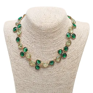 Detailed view of the luxury rhinestone crystal necklace, featuring vibrant green and yellow stones.