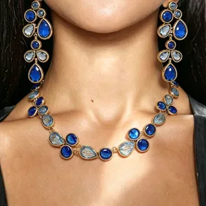 Stunning blue crystal teardrop statement necklace and earrings set with gold-tone finish for women.