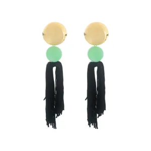 Detailed view of bohemian long tassel earrings with gold disc and green bead elements.