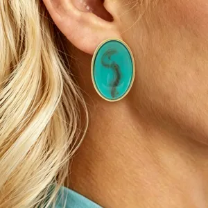 Elegant oval resin stud earring close-up, premium teal gemstone texture with gold metal rim.