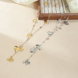 Detailed shot of the elegant long Y-shaped chain necklace featuring exquisite metal leaves.