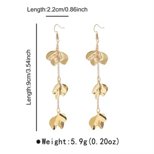 Detail view of long gold metal leaf tassel earrings showcasing exquisite craftsmanship and dimensions.