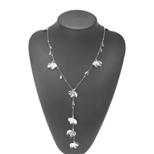 Detailed view of a silver Y-shaped long necklace featuring elegant metal flower and leaf charms.