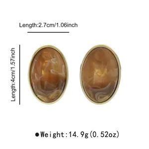 Vintage oval marbled resin stud earrings with metallic rim, lightweight elegant jewellery design.
