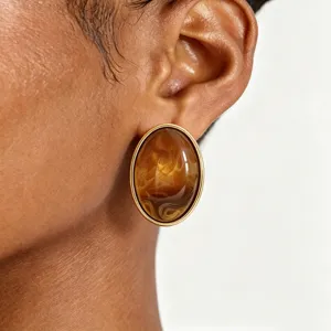 Elegant vintage amber swirled resin stud earrings with gold rim for women daily wear.