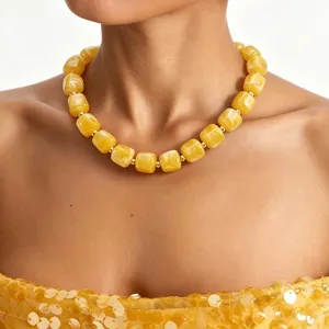 Chunky yellow acrylic beaded statement necklace close up view for stylish women fashion jewelry.
