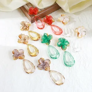 Detail view of stylish acrylic flower fabric drop earrings in various vibrant colors.