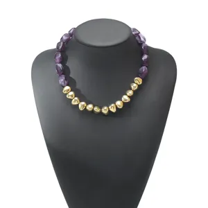 Detailed view of the vintage irregular resin and metallic heart bead necklace fashion jewelry.