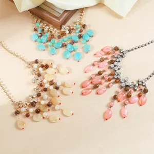 Detailed view of colorful stone tassel necklaces with rhinestone and delicate chain designs.