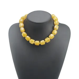 Chunky yellow acrylic statement necklace for women, bold geometric beaded boho jewelry.
