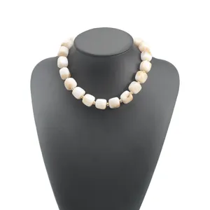 Chunky beige acrylic cylindrical beaded necklace, bohemian fashion statement jewelry for women.