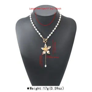 Detailed view of the sweet cool style frangipani pendant necklace with pearl chain and OT clasp.