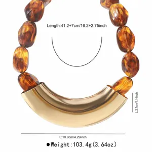 Detailed view of handmade resin beaded necklace with large gold curved metal pendant and specs.