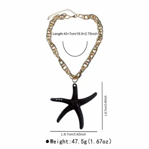 Chunky gold chain necklace with a stylish black resin starfish pendant, beach vacation style.