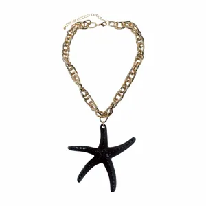 Gold chunky chain necklace with black resin starfish pendant, stylish beach resort jewelry.