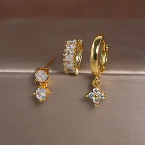 Goudkleurige koperen zirkonia oorbellen set van 3, met stijlvolle klaverhanger en ringen.