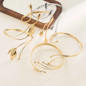 Fashion geometric metal open arm cuff bracelet set with leaf and drop design details.