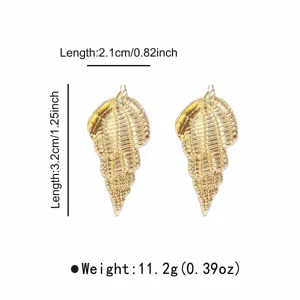 Detail view of the elegant golden conch shell earrings, showing exquisite texture.