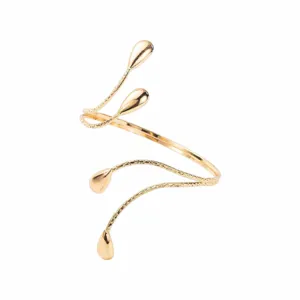 Close-up of the textured gold-tone open arm cuff showing intricate droplet ends and metal finish.