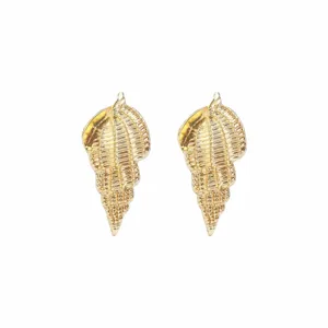 Close-up detail of golden conch shell earrings, showing exquisite textured metal design.