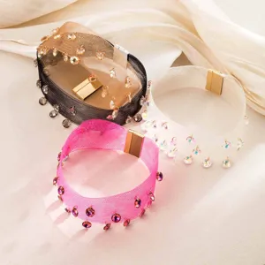 Close-up detail of stylish mesh crystal pendant chokers in multiple colors with magnetic clasp.