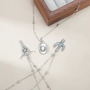 Western cowboy style silver necklace set featuring bull skull cactus turquoise charms jewelry