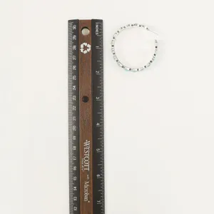 Detail shot of vintage western style turquoise hoop earrings with clear size reference ruler.