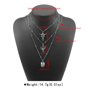 Vintage western cowboy multi-layer necklace set with bull skull and cactus pendant details.