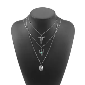 Western vintage multi-layer necklace set featuring bull skull cactus and cowboy hat pendants.