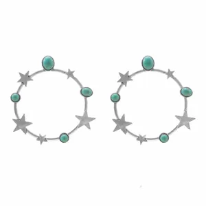 Detailed close-up of vintage western style silver hoop earrings with turquoise stones and stars.