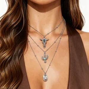 Western cowboy style layered necklace set with bull skull and turquoise cactus pendants.